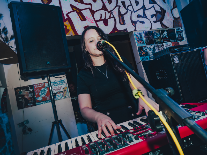 Photo of a piano player on stage at the Probably House